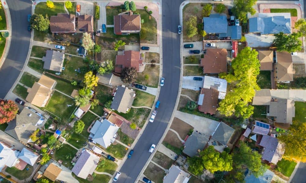 Aerial view of a residential neighborhood with homes, driveways, streets, and individual property lots, representing a property setting for a loan closing survey